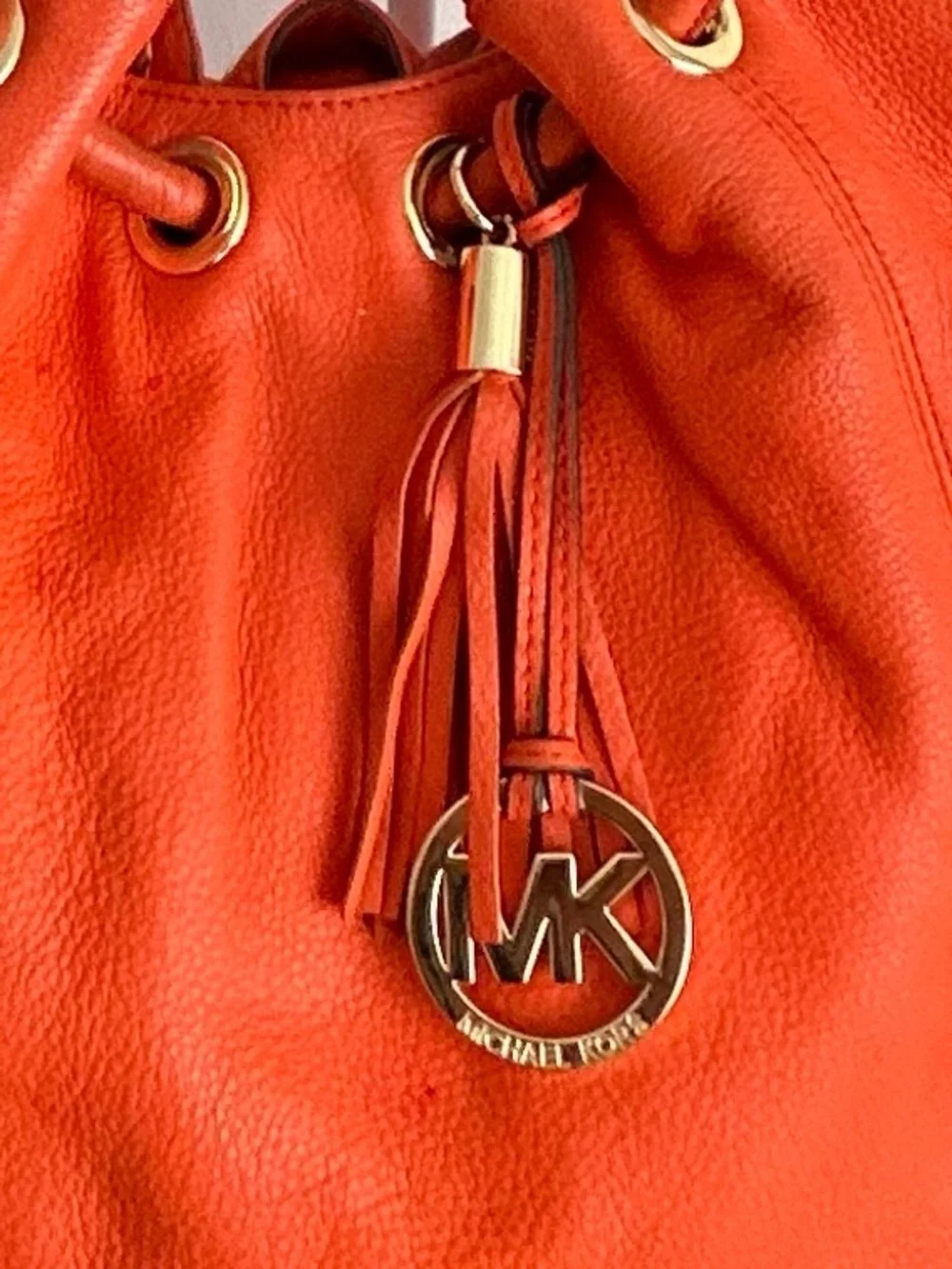 Michael Kors Orange Pebbled Leather Drawstring Tote tassel shoulder bag